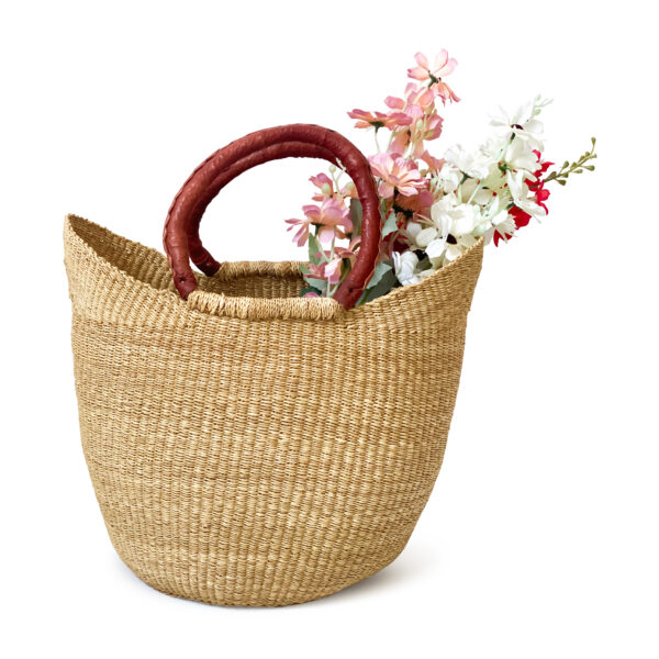 a bolga shopper basket with flowers in it