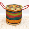 a colorful bolga woven laundry basket with lid