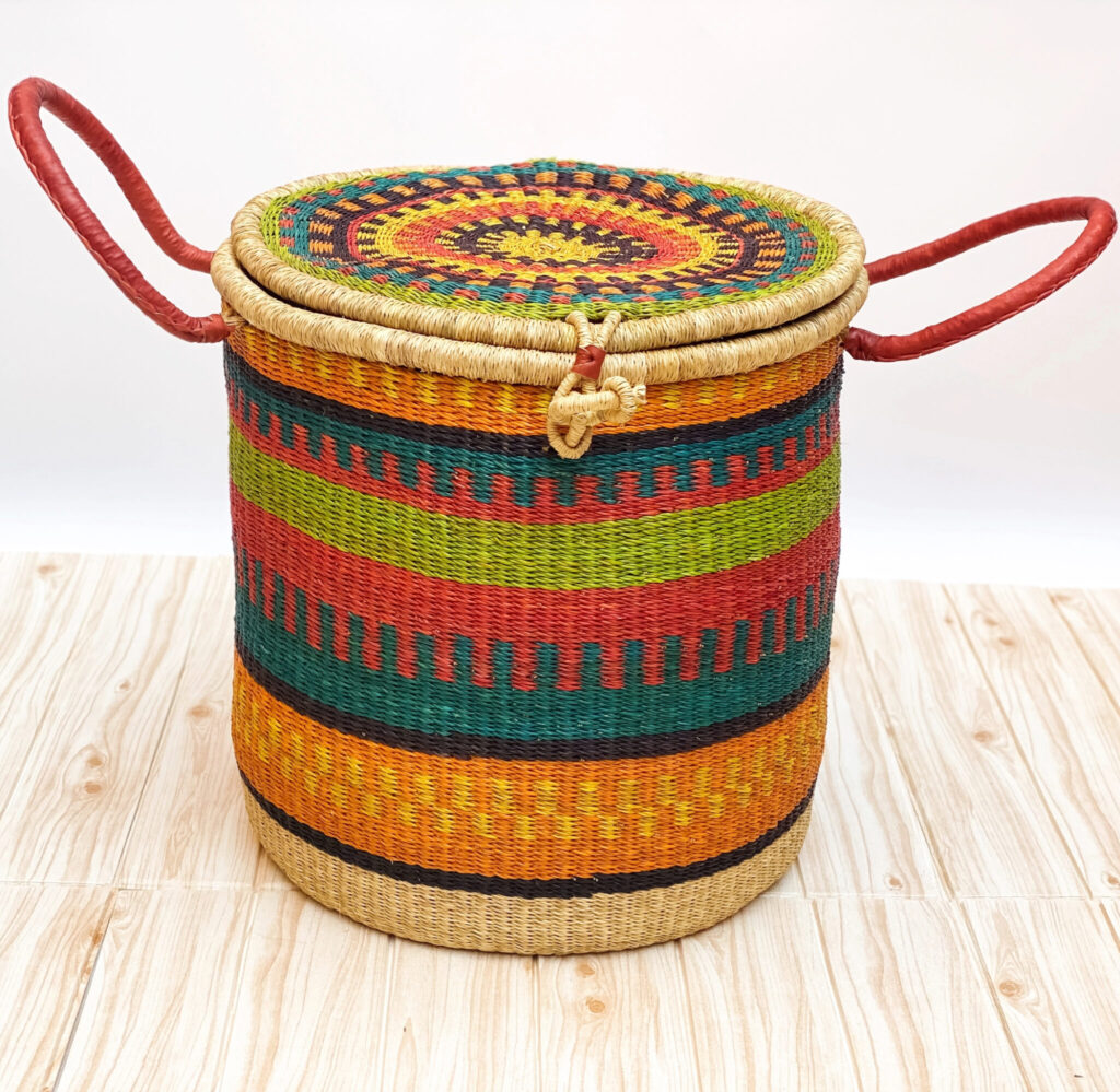 a colorful bolga woven laundry basket with lid