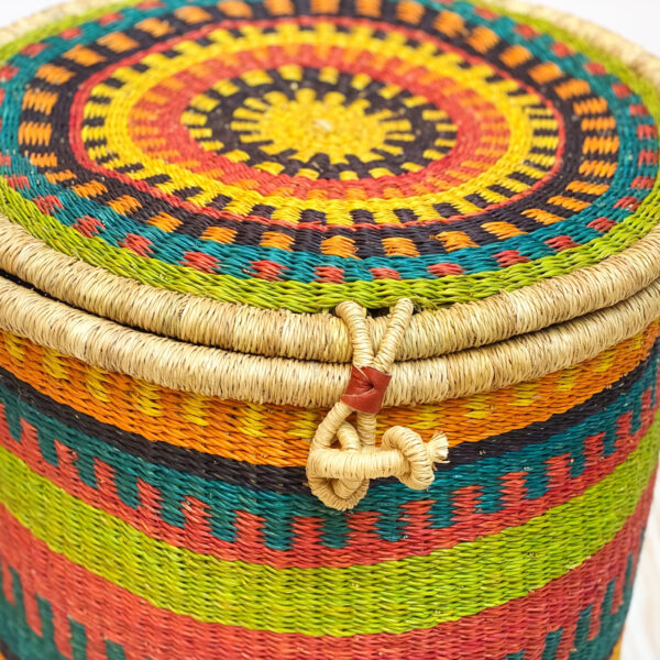 a colorful lidded bolga woven laundry basket