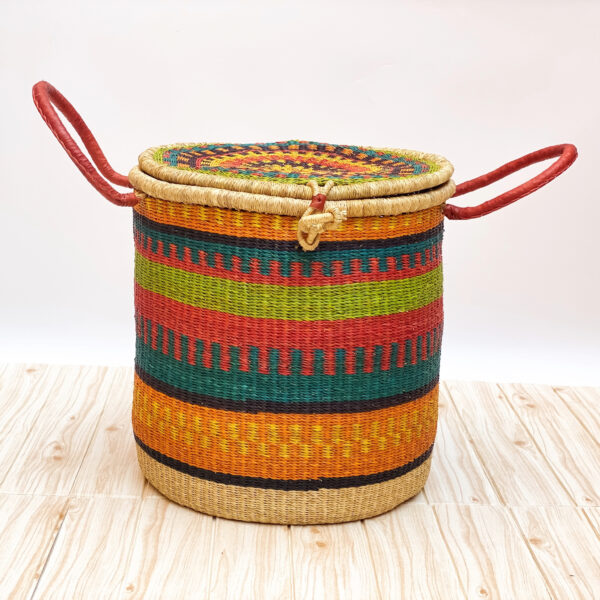 a colorful woven laundry basket with lid and handles