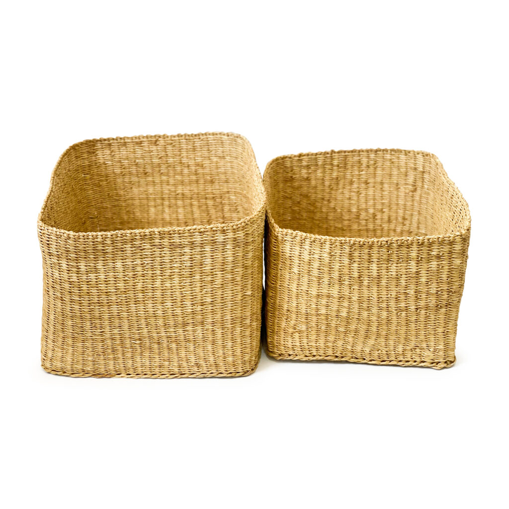 two rectangular woven baskets on a white backdround