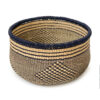 a round woven basket on a white background