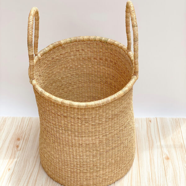 a woven laundry basket with handles