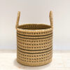 a bolga woven laundry basket with handles