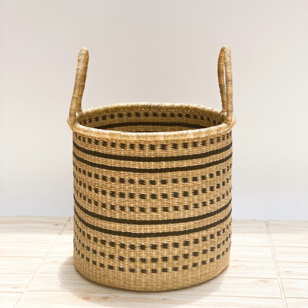 a bolga woven laundry basket with handles