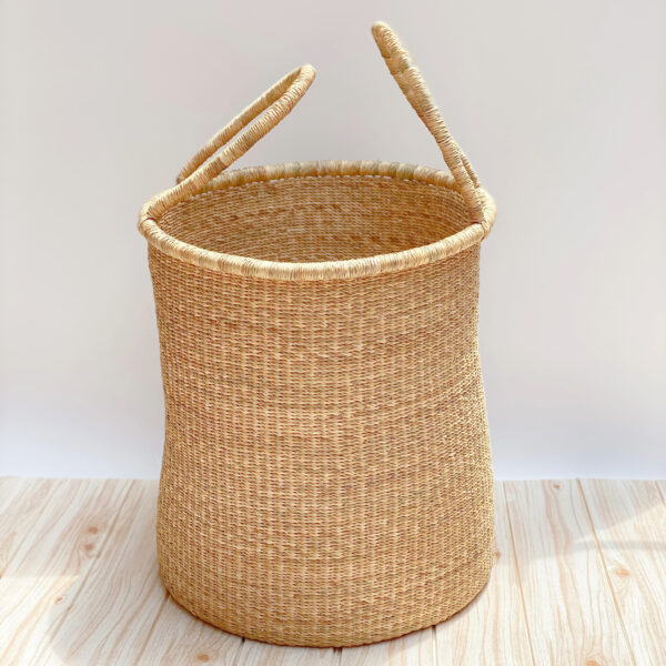 a woven laundry basket with handles