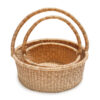 a stack of woven picnic baskets with handles on a white background