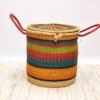 large colorful woven laundry basket with lid and handles