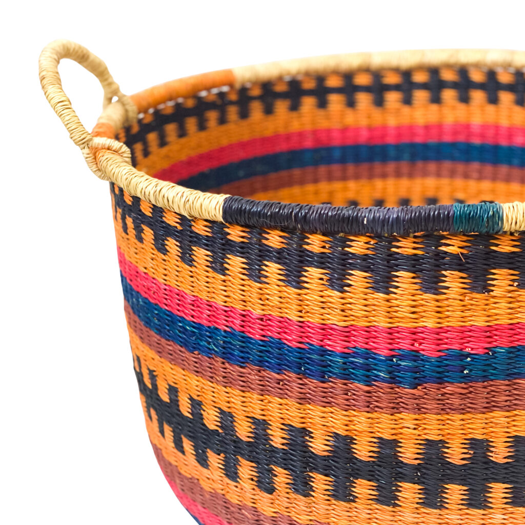 a woven colorful floor basket with handles