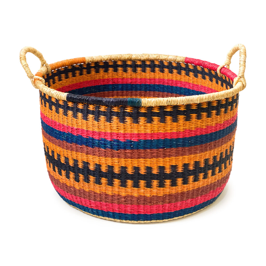 a woven colorful floor basket with handles